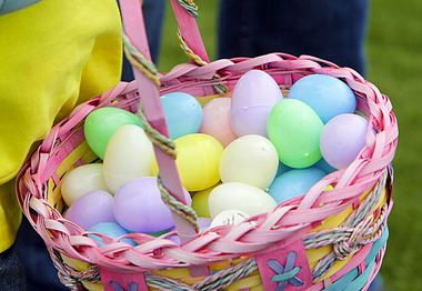 A child carries away her basket filled with plastic eggs after participating in an easter egg hunt this morning sponsored by the Newark City Council at the Ironbound Stadium Saturday April 4, 2009. (Tony Kurdzuk/The Star-Ledger)